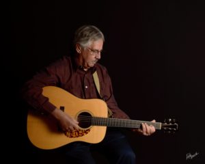 Roger playing his guitar